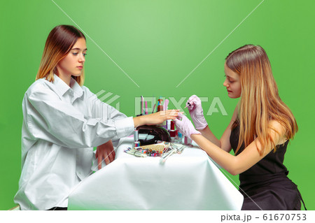 Little girl dreaming about future profession of nails manicure artist 61670753