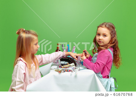 Little girl dreaming about future profession of nails manicure artist 61670768