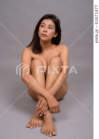 Sensual Asian woman naked while sitting on the floor 61671877
