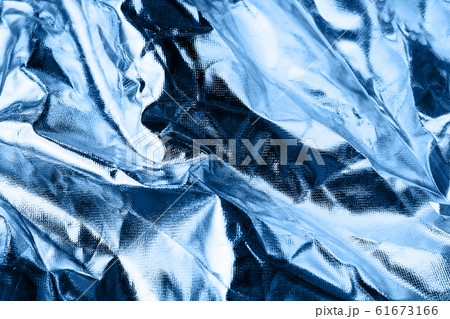 Shiny crumpled foil surface in trendy blue color for textured background. Color of the year 2020 concept. 61673166