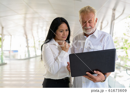 Mature multi-ethnic couple happy and in love while exploring the Mature multi-ethnic couple happy and in love while exploring the 61673609