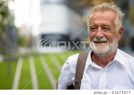 Handsome senior tourist man exploring the city of Bangkok, Thail 61673877