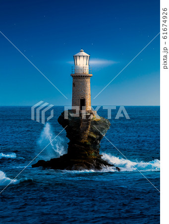 The beautiful Lighthouse Tourlitis of Chora at night. Andros island, Cyclades, Greece 61674926