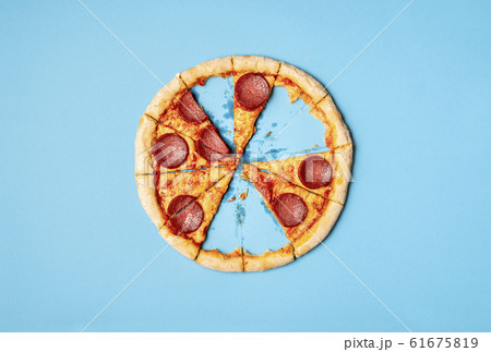 Pizza salami with missing slices and leftover Pizza salami with missing slices and leftover 61675819