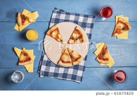 Margherita pizza slices and drinks. Party table 61675820