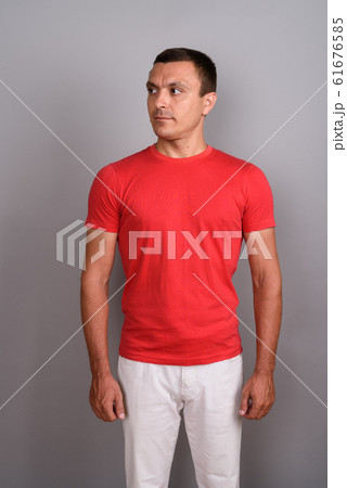 Man wearing red shirt against gray background 61676585