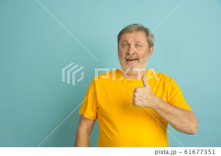 Caucasian senior man's portrait isolated on blue studio background 61677351