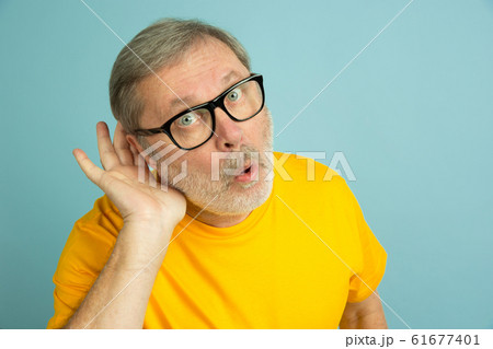 Caucasian senior man's portrait isolated on blue studio background Caucasian senior man's portrait isolated on blue studio background 61677401