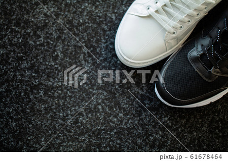 Pair of new stylish sneakers on floor at home. 61678464