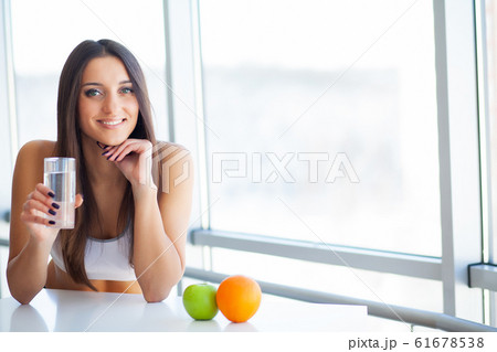 Beautiful Smiling Woman Taking Vitamin Pill. Dietary Supplement Beautiful Smiling Woman Taking Vitamin Pill. Dietary Supplement 61678538