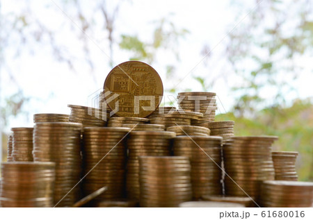 Big amount of bitcoin stacks on blurred green 61680016