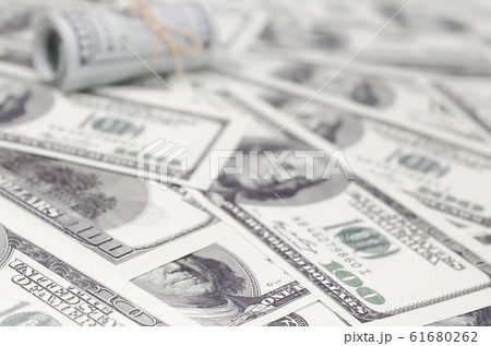 US dollars rolled up and tightened with band lies 61680262