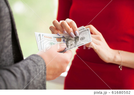 Business. Business Woman Gives Money to Men. Woman Dressed in Re Business. Business Woman Gives Money to Men. Woman Dressed in Re 61680502