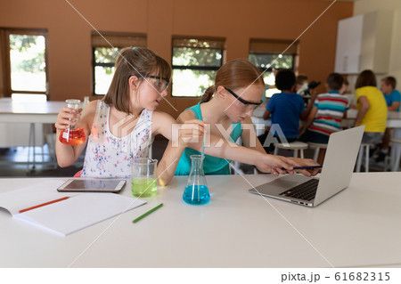 Two elementary school girls in chemistry class 61682315