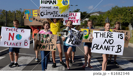 Group of elementary school pupils walking on a protest march Group of elementary school pupils walking on a protest march 61682346