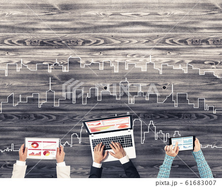 Top view of businesspeople sitting at table and using gadgets Top view of businesspeople sitting at table and using gadgets 61683007