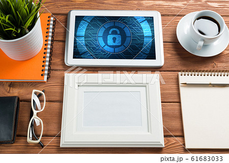 Web security and technology concept with tablet pc on wooden table 61683033