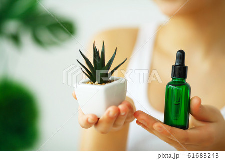 Beauty and Care. Close Up Hands For Women Who Hold A Face Cream. Cosmetology. Woman with Beautiful Blue Eyes. Skin Care 61683243