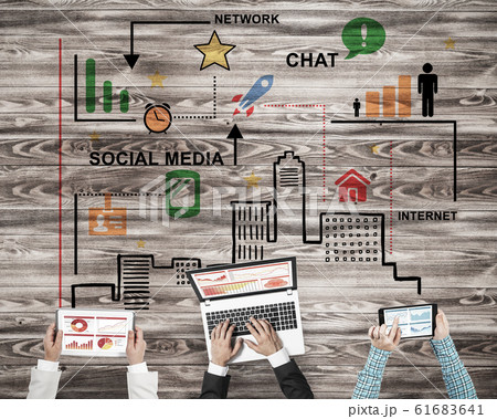 Top view of businesspeople sitting at table and using gadgets Top view of businesspeople sitting at table and using gadgets 61683641