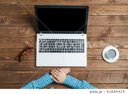 Top view of woman sitting at wooden table and working with laptop 61684424