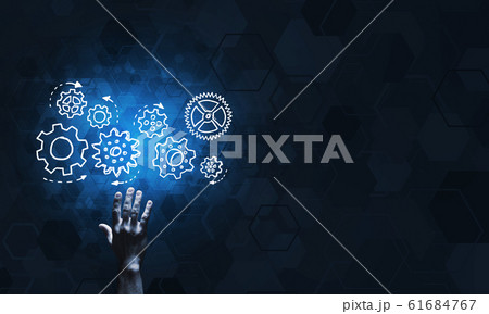Glowing cogwheel mechanism icon on dark background as symbol of teamwork 61684767