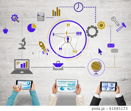 Top view of businesspeople sitting at table and using gadgets Top view of businesspeople sitting at table and using gadgets 61685173