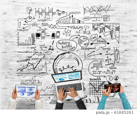 Top view of businesspeople sitting at table and using gadgets Top view of businesspeople sitting at table and using gadgets 61685261