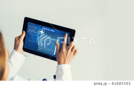 Close of female doctor hands working with tablet pc computer Close of female doctor hands working with tablet pc computer 61685503