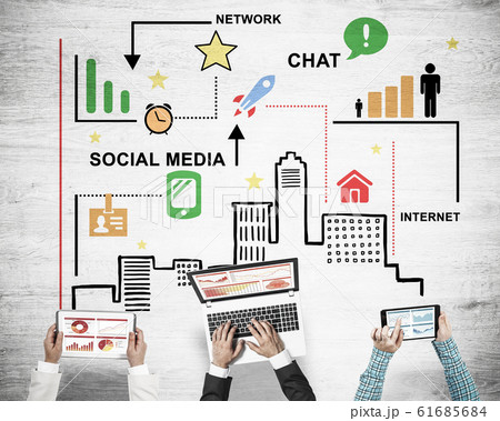 Top view of businesspeople sitting at table and using gadgets Top view of businesspeople sitting at table and using gadgets 61685684