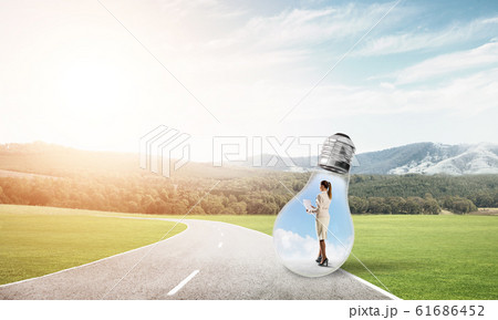 Businesswoman inside light bulb 61686452