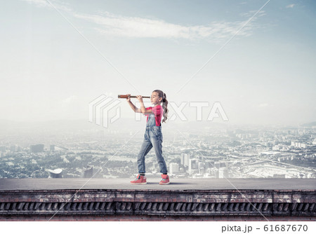 Concept of careless happy childhood with girl exploring this wor 61687670