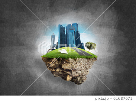 Modern cityscape with towers and skyscrapers on green part of land 61687673