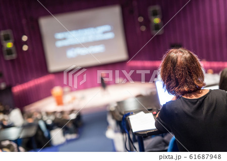 Audience in the lecture hall attending business conference event. Audience in the lecture hall attending business conference event. 61687948
