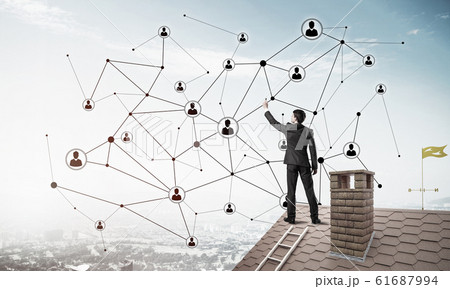 Businessman on house roof presenting networking and connection c 61687994
