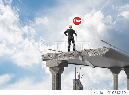 Confident engineer holding street safety sign. 61688240