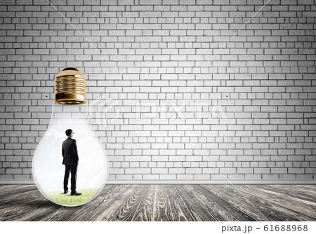 Businessman trapped in bulb Businessman trapped in bulb 61688968