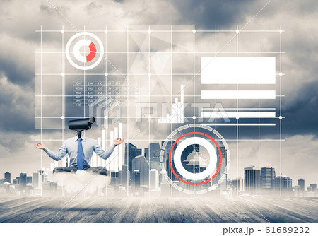 Camera headed man sitting in lotus pose on cloud against modern Camera headed man sitting in lotus pose on cloud against modern 61689232