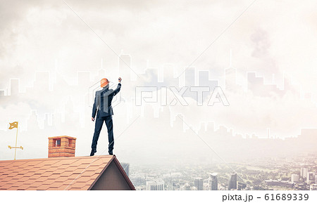 Man architect draw silhouette of modern city on blue sky. Mixed Man architect draw silhouette of modern city on blue sky. Mixed 61689339