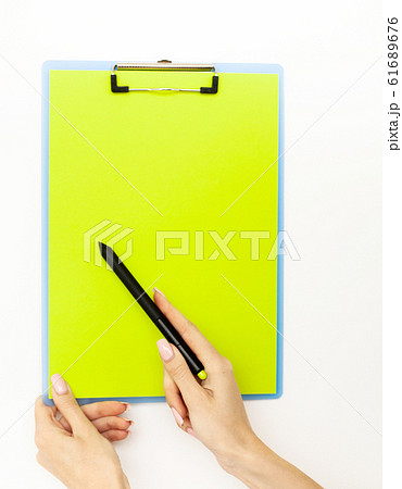 Blank Folder with Green Paper. Hand that Holding Folder and Pan Handle on White Background. Copyspace. Place for Text Blank Folder with Green Paper. Hand that Holding Folder and Pan Handle on White Background. Copyspace. Place for Text 61689676