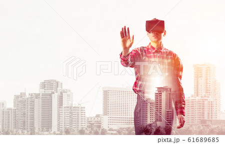 Guy wearing checked shirt and virtual mask stretching hand to to 61689685