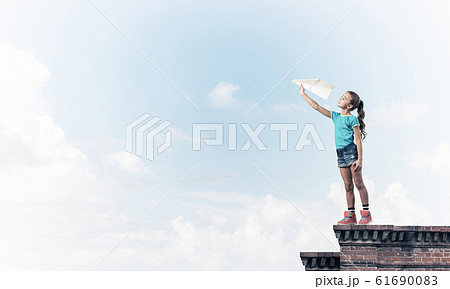 Concept of careless happy childhood with girl dreaming to become Concept of careless happy childhood with girl dreaming to become 61690083