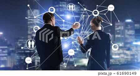 Concept of social connection and networking against night city view and partners working in cooperation 61690149