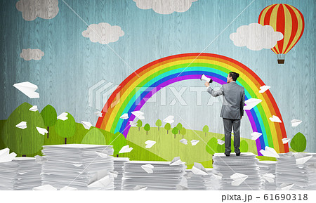 Businessman standing with megaphone. 61690318