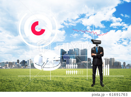 Camera headed man standing on green grass against modern cityscape Camera headed man standing on green grass against modern cityscape 61691763