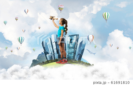 Concept of careless happy childhood with girl dreaming to become pilot Concept of careless happy childhood with girl dreaming to become pilot 61691810