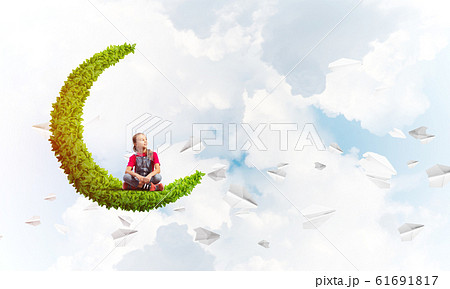 Concept of careless happy childhood with girl on green moon Concept of careless happy childhood with girl on green moon 61691817