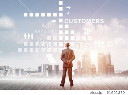 Pensive businessman looking at user interface against modern city background Pensive businessman looking at user interface against modern city background 61691870