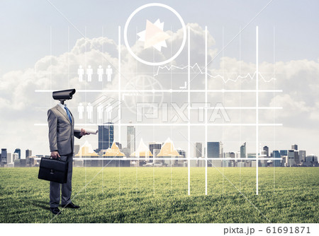 Camera headed man standing on green grass against modern citysca Camera headed man standing on green grass against modern citysca 61691871
