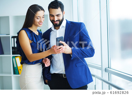 Young colleagues at work in modern office Young colleagues at work in modern office 61692826