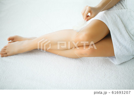 Closeup of a woman showing perfect smooth legs Closeup of a woman showing perfect smooth legs 61693207